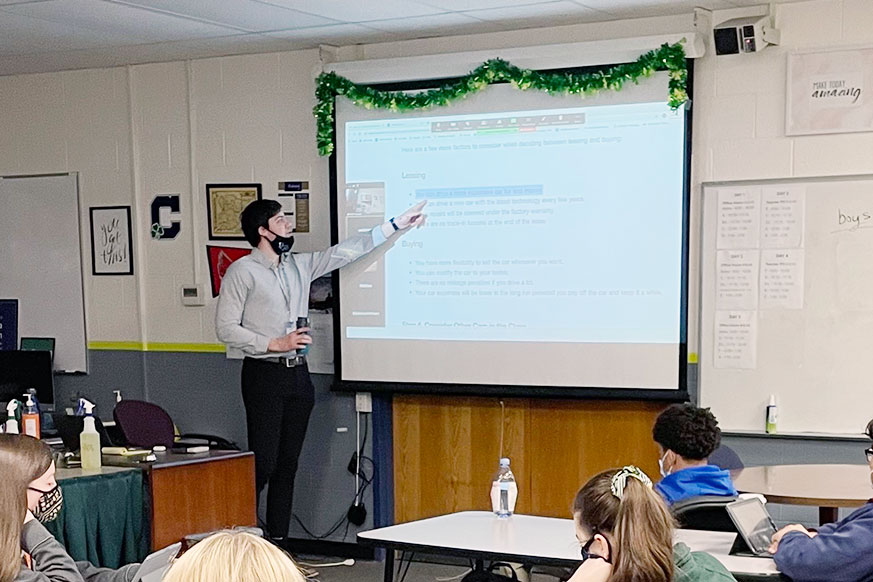 During his E period personal financial responsibility class, Mr. Brendan Surane reviews material with his students. Surane plans to have one of his courses next year with students operating a coffee shop in the Innovation Center. 