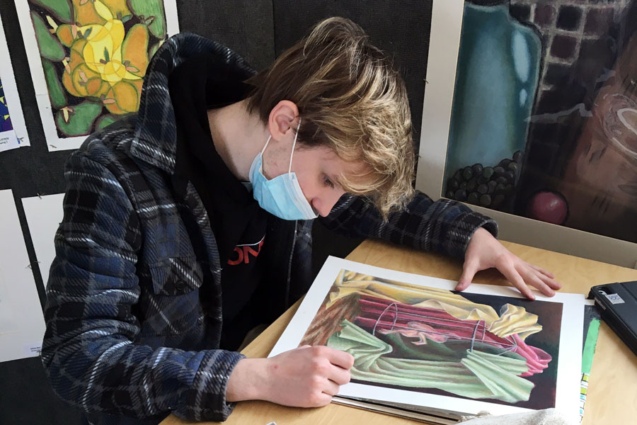 Senior Hays Teasley puts the finishing touches on one of his works of art. 