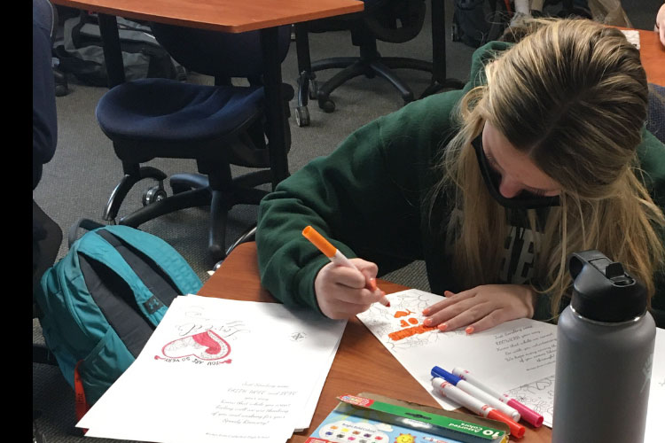 Sophomore Gabrielle Blamey colored greeting cards to help complete her required service hours. 