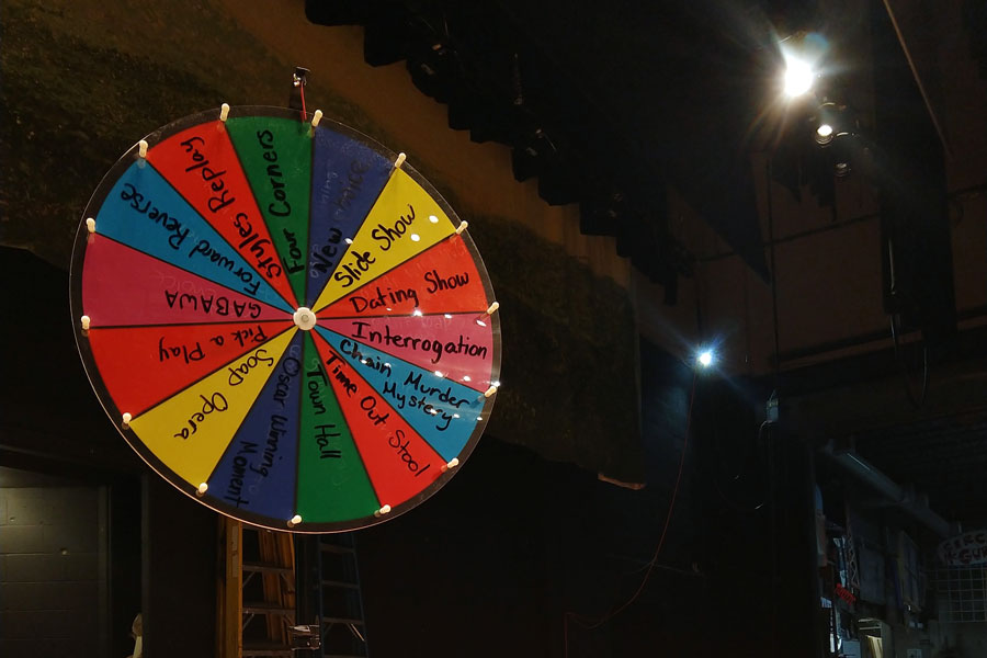 A wheel on the auditorium stage helps the improv team select its next skit. 
