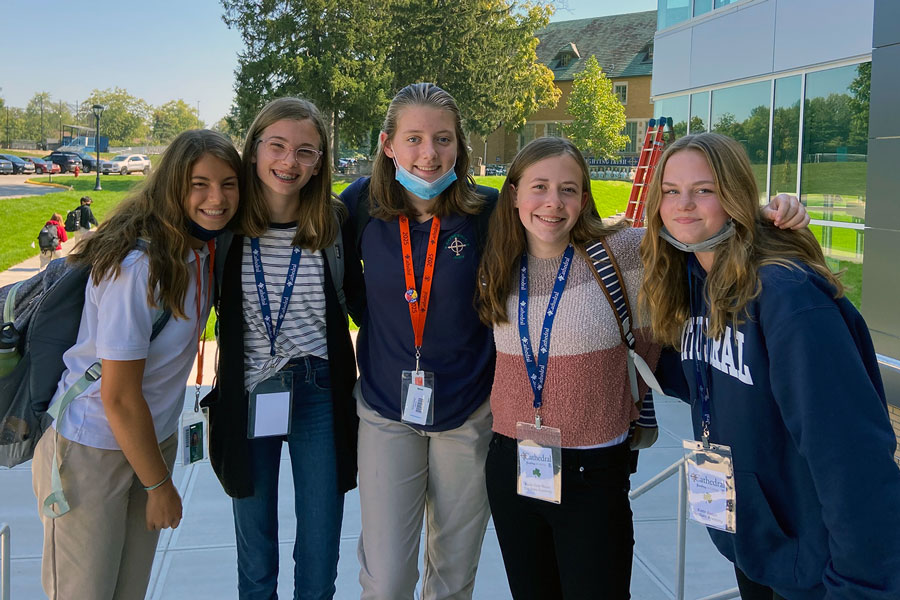 A group of eighth-graders and their host gather outside the Innovation Center at the end of their visit to campus. 