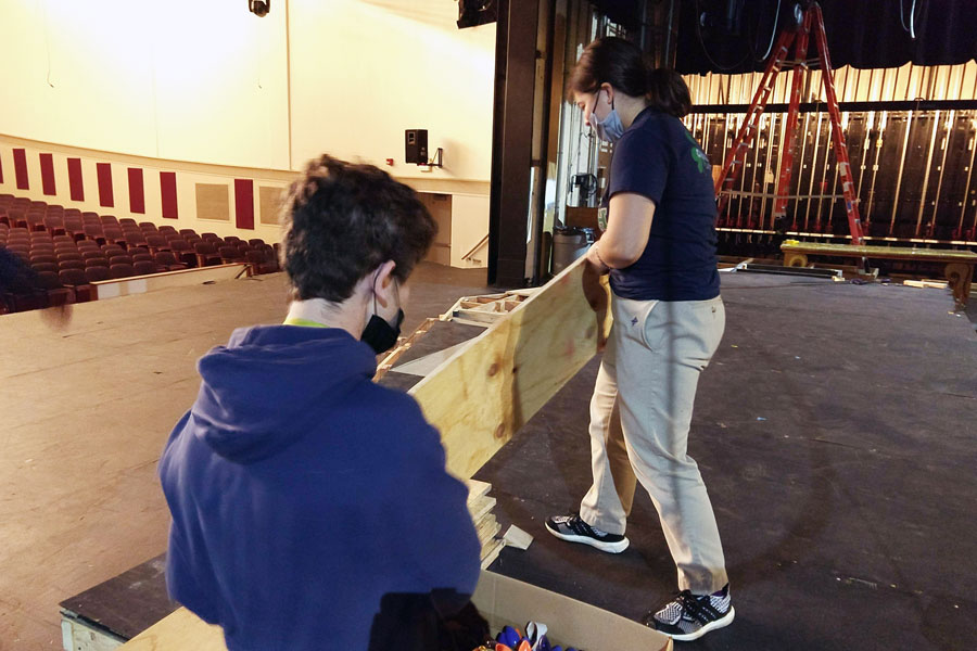Members of the crew work to prepare the stage for the fall play. 
