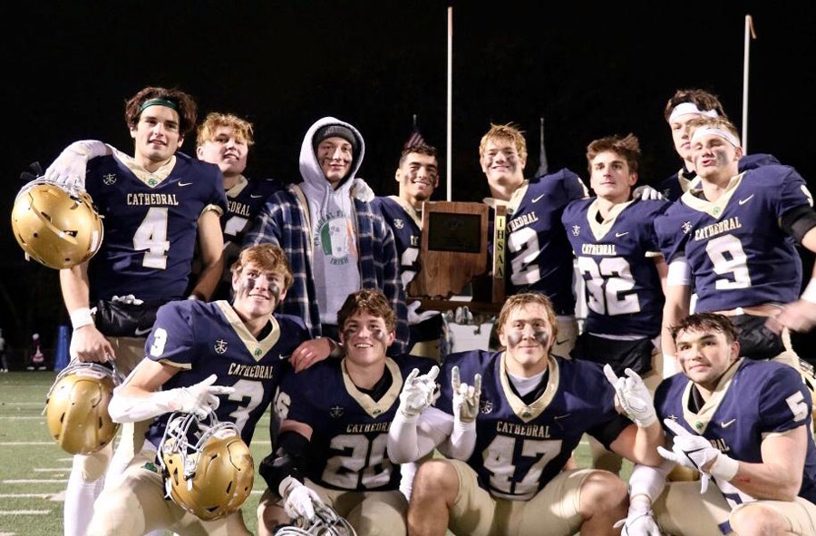 After their 23-7 win over New Palestine, members of the varsity football team show off their Regional trophy. 