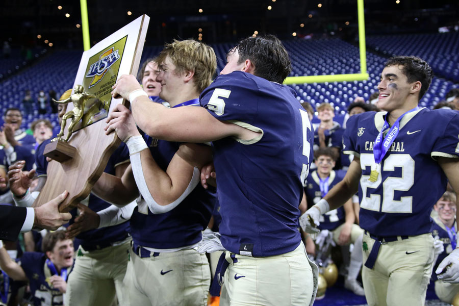 After their 34-14 win over Zionsville, members of the varsity football team show off the Class 5A State championship trophy. 