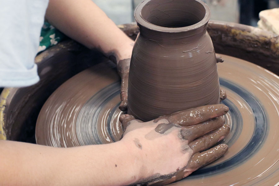 A student uses the wheel in Mrs. Sara Greene's J-Term ceramics class. 