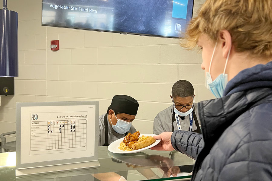 In the dining hall, a student makes his selection for lunch. While the FLIK staff ensure that students are informed about potential food allergies, it is up to students to make selections in order to avoid menu items that would expose them to such allergies.