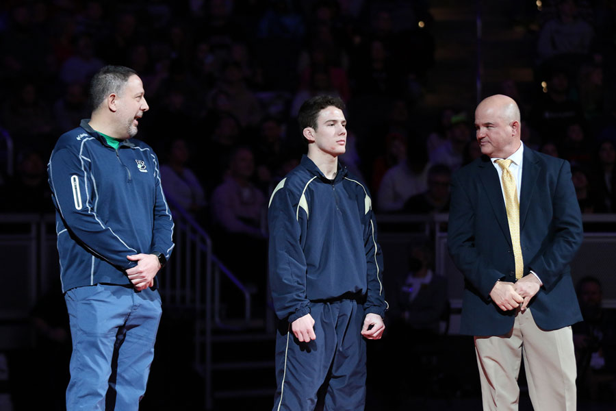 Just prior to his introduction to the crowd at Gainbridge Fieldhouse before his State championship match, senior Zeke Seltzer stands with his father, Mr. Brian Seltzer (left) and his head coach, Mr. Sean McGinley ‘88 (right).