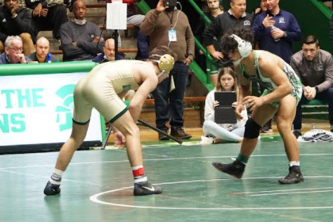 Senior Zeke Seltzer, left, competes in the Semistate at New Castle on Feb. 12. He and six fellow team members will wrestle in the State Finals on Feb. 18 and Feb. 19. 