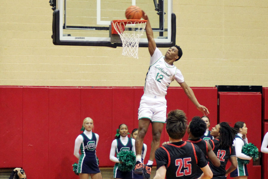 During the opening game of the Sectional, senior Tayshawn Comer jams home a basket against North Central. 