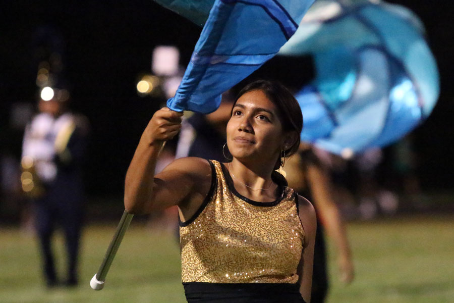 During halftime of a varsity football game last fall, senior Jennifer Ventura participates as a member of the color guard. 