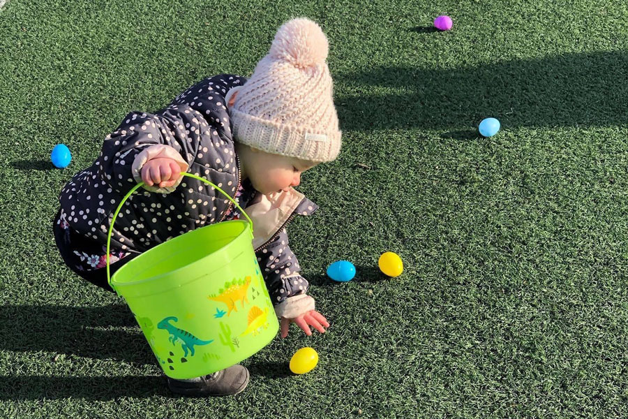 A participant is last year's Easter egg hunt is egg-cited to add another egg to their basket. 