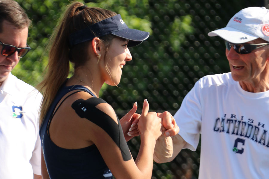 During the team's Senior Night against Westfield, senior Sara Wojtalik bumps fists with Assistant Coach Mr. Joe Lustig.