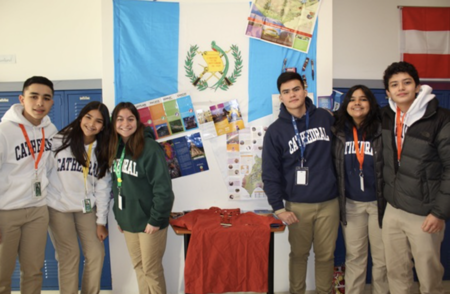 The six exchange students standing in front of the Guatemalan Flag.