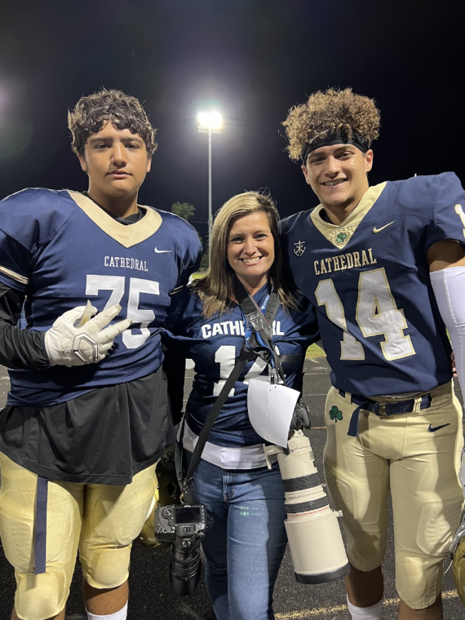 Lacey Nix with her camera on standby at a Cathedral football game with her sons, Caleb Martin ‘23 and Kaiden Martin ‘26