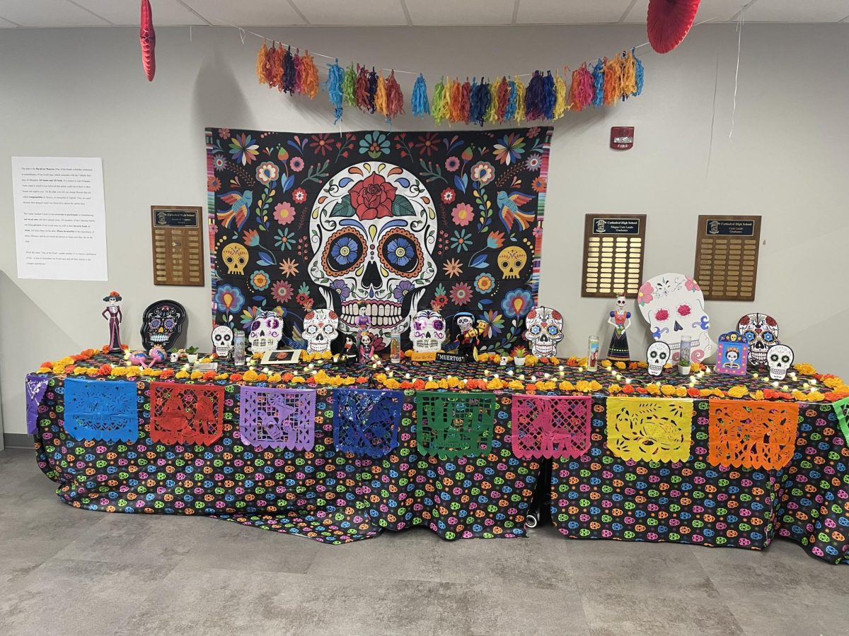 The Latino Student Union built this ofrenda located between Kelly Hall and the Innovation Center to celebrate El Día de los Muertos. The altar structure has pictures of loved ones who have passed away from the Cathedral community along with items to remember them. 