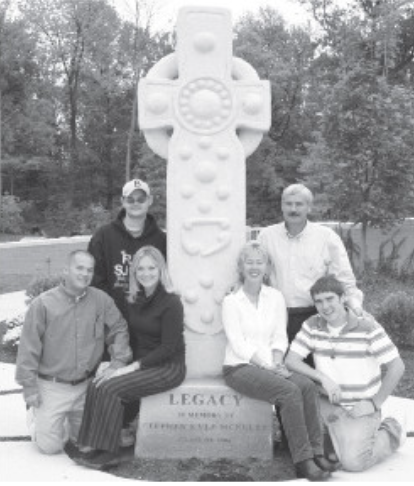 “The McNulty family at the dedication of the cross in October 2006. Front row, from left: Jason McClellan 98, Kristin McNulty-McClellan 98, Jacque McNulty 78 and Patrick McNulty 08. Back row, from left: Brad McNulty 01 and Jerry McNulty 76. 17 years later, the cross still shows Stephen’s legacy and love. 
(https://mycathedrallegacy.com/meet-our-donors/creating-a-true-legacy-at-cathedral)