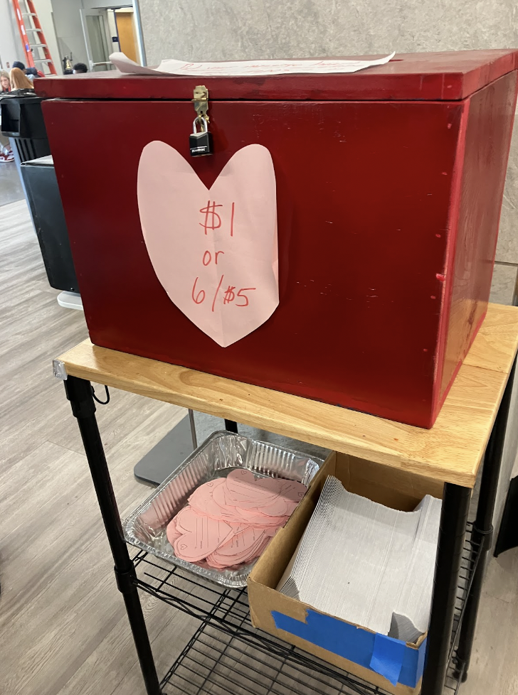 The Candy Gram station is set up in the Dining Hall. Paper hearts and envelopes are provided at the station for students to write notes. “It goes towards a great cause,(Leukemia)” said Mrs. Ford