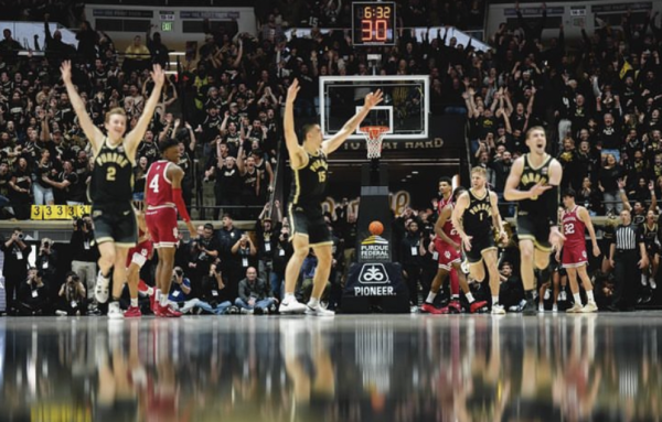 The Purdue basketball team celebrates after Zach Edey hit his first ever 3-pointer in a college game. Edey is a center, meaning he does not usually shoot from the field, making this a comical and exciting thing to happen. Edey joked in an interview with ESPN after the game, saying “I’m the best shooter in the country.” (ESPN.com)

Photo from @Boilerball Instagram