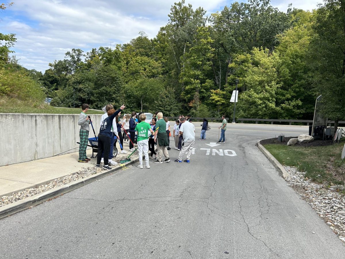 Mr. Quaranta's 9th grade resource class shovels rocks off the drive during C period. Classes were asked to sign up during the day for service on campus. "I wanted my freshmen to do an hour of service because they didn't get to experience the bigger service day off campus last year," said Mr. Q.