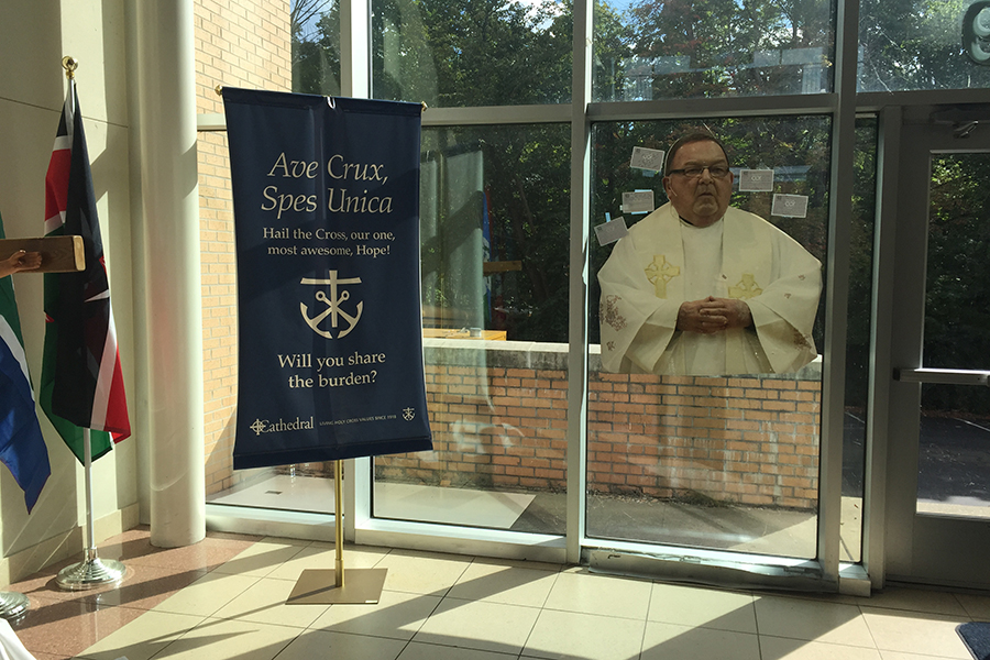 Fr. John Zahn's image graces the atrium outside the auditorium. His funeral is Sept. 6 at the cathedral in Lafayette. 