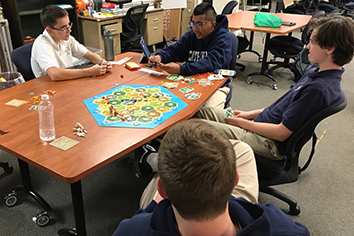 Freshman Hector Perez and sophomores Anthony DeSanto, Ethan Downs and Ethan Emery  
develop their settlements. 