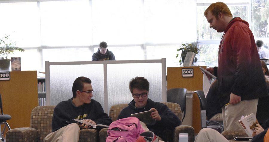 Seniors David Bishop, Nicolas Widel and Daniel Willey work on their iPads.
