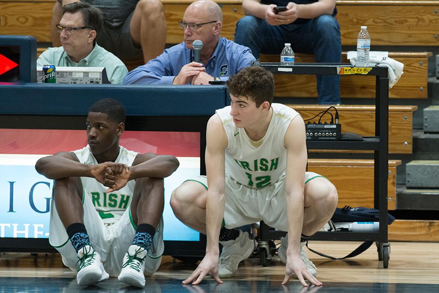 During the varsity's Feb. 19 game against Lighthouse Christian Academy, seniors Jayden Edwards and Jacob Ball wait to check it. The team will open Sectional play on Feb. 27. 