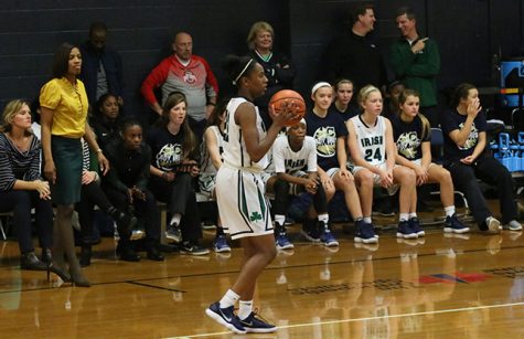 During a regular season game in the auxiliary gym that was moved from the WAC due to a water leak, Head Coach Mrs. Reggen Nelson directs her team. 