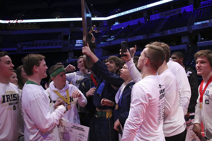 The Irish wrestlers raise the State championship trophy Feb. 17 at Bankers Life Fieldhouse. 