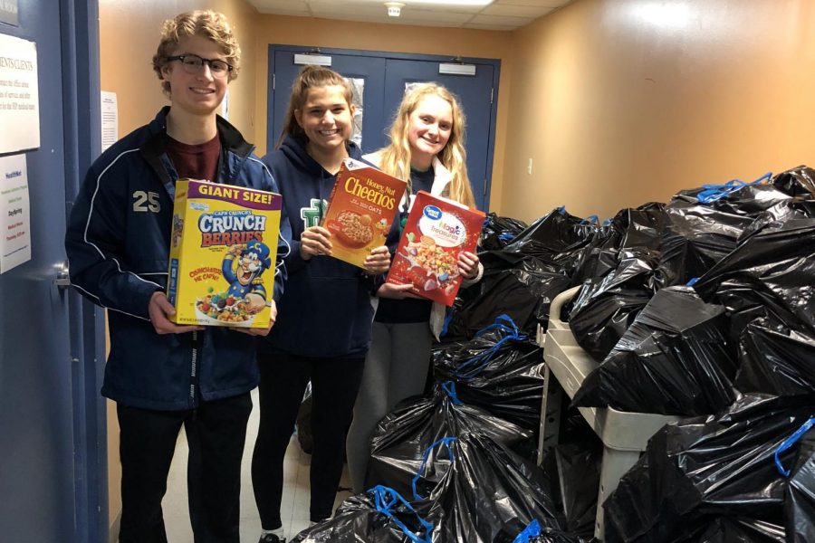 Students pose with the heaps of collected cereal.