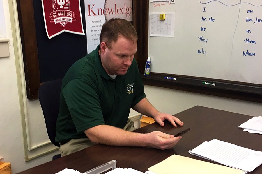 Mr. Matt Panzer works at his desk in his classroom on the second floor of Loretto Hall. 