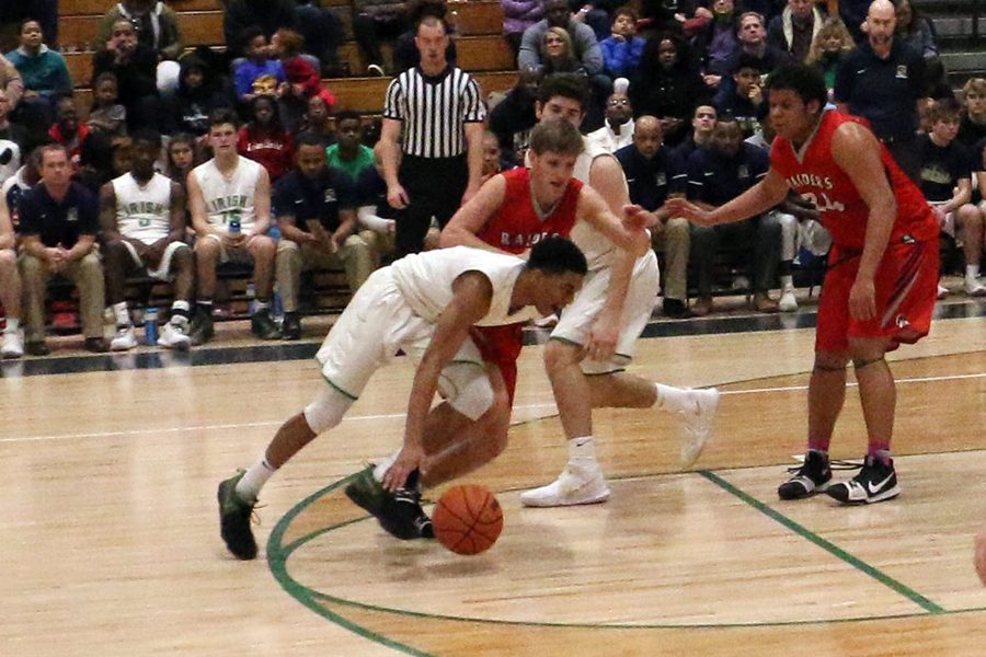 During the regular season game in the WAC, senior Jarron Coleman drives on his Roncalli defender. The men's varsity team opens Sectional play on Feb. 27 against Lawrence North. 