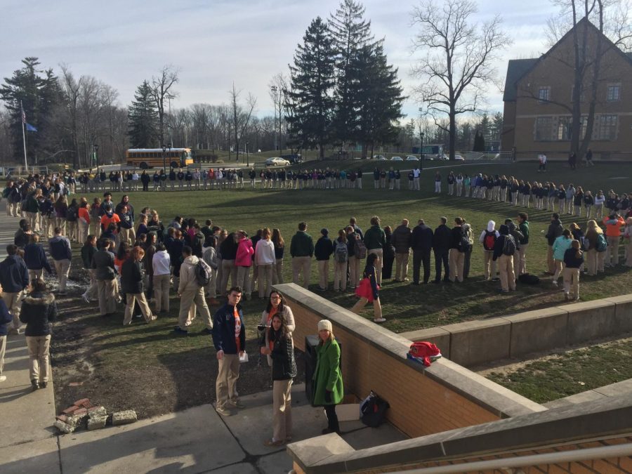 Walkout participants gather in prayer circle in support of both Stoneman Douglas and gun reform.