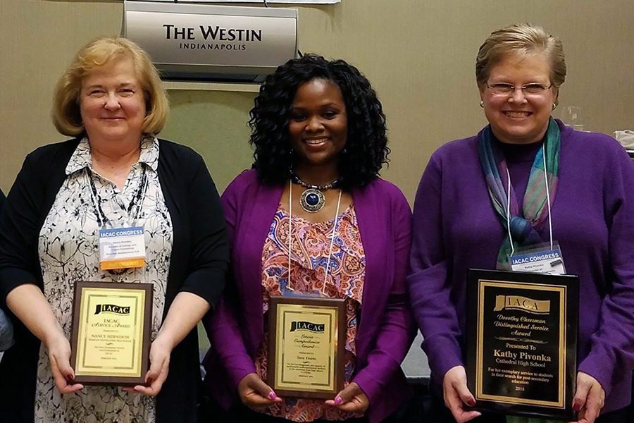 Ms. Kathy Pivonka, far right, shows off her award. 