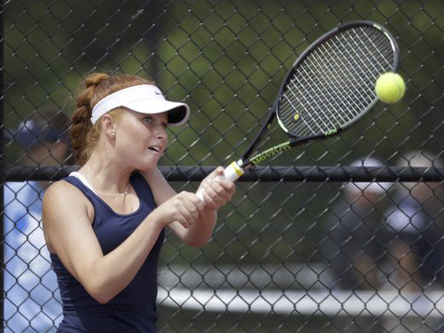 Senior Maeve Koscielski returns a volley in a match last spring.