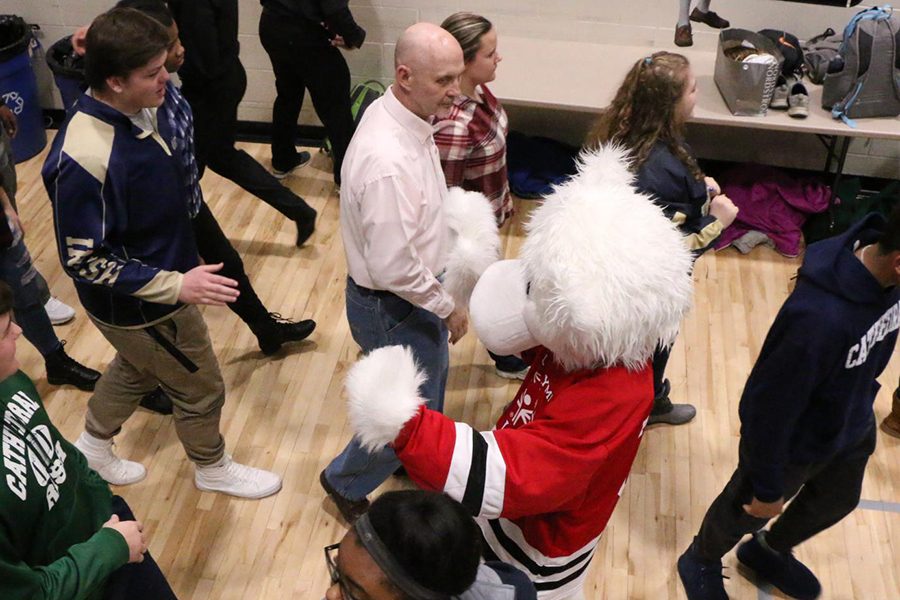 Mr. Ken Jensen, center, enters the Welch Activity Center for the Winterfest assembly. 