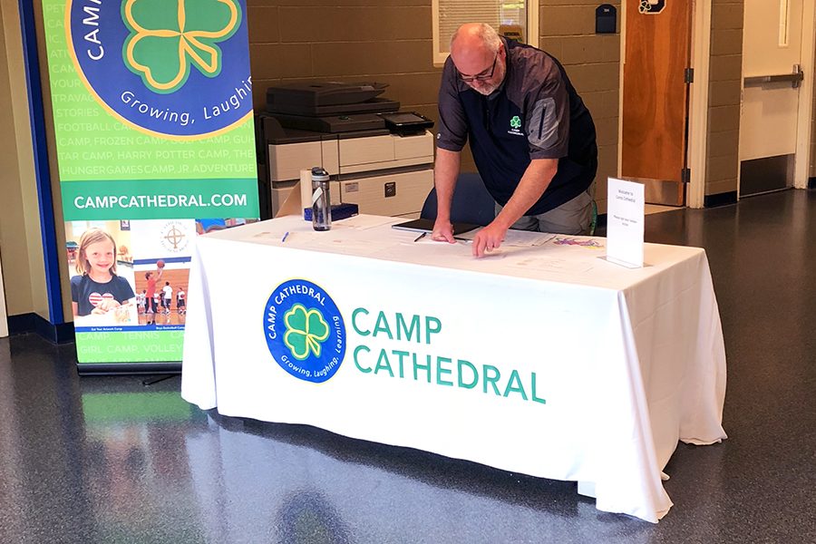 Last summer in the Shiel Student Life Center, Camp Cathedral director Mr. Anthony Ernst prepares to check in that morning's participants. 