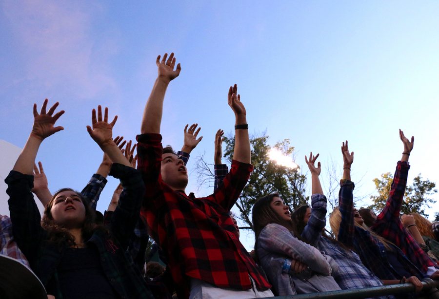 Friday nights are for football, and have been for many years for Head Coach Mr. Bill Peebles '88. Students on the front row cheer for the Irish during the Homecoming game. 