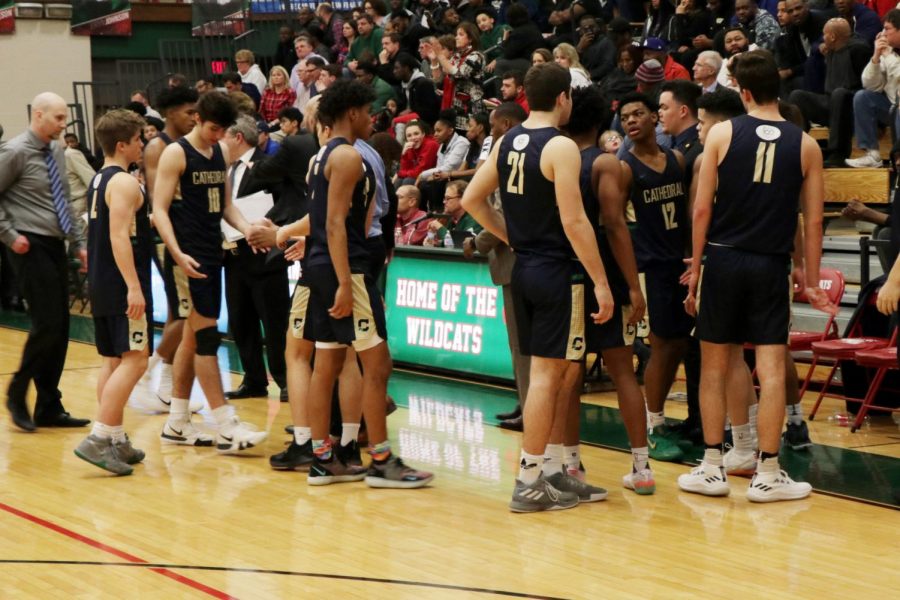 Head Coach Mr. Jason Delaney gathers his team during the Sectional opener on Feb. 26 at Lawrence North.