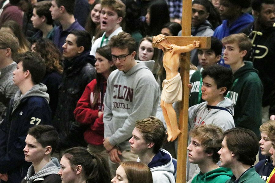 The crucifix is brought down the center aisle in the Welch Activity Center during a Mass that was celebrated during the 2019-2020 school year. 