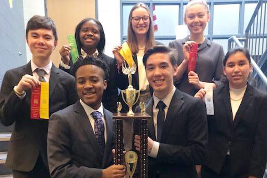 The sophomores who have qualified for the State meet on March 9 show off the Sectional championship trophy, which the entire team captured at Perry Meridian. 