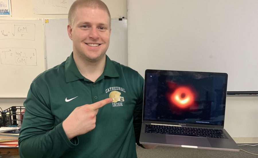 In his classroom in the basement of Kelly Hall, astronomy and physics teacher Mr. Adam Hibshman shows off the image a black hole. He said he will explain to his classes the importance of the photo and the factors that led to scientists being able to capture the image. 