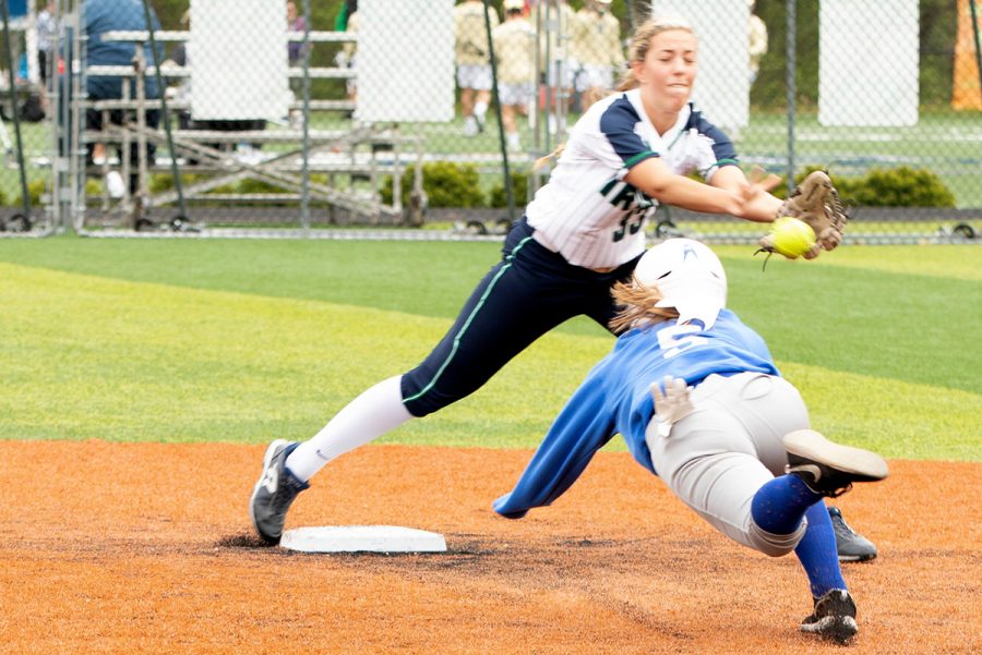 During the opening round of the City softball tournament on April 27, the Shortridge runner beats the throw to junior Grace Lorsung. The Irish would go on to win 12-0. 