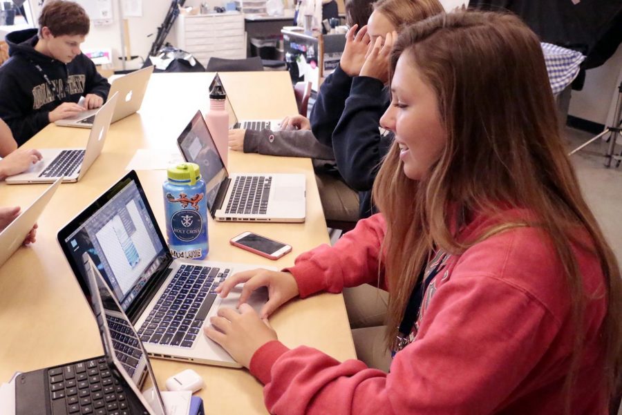 Senior Emma Doyle works on her laptop on another graphic design class project. 