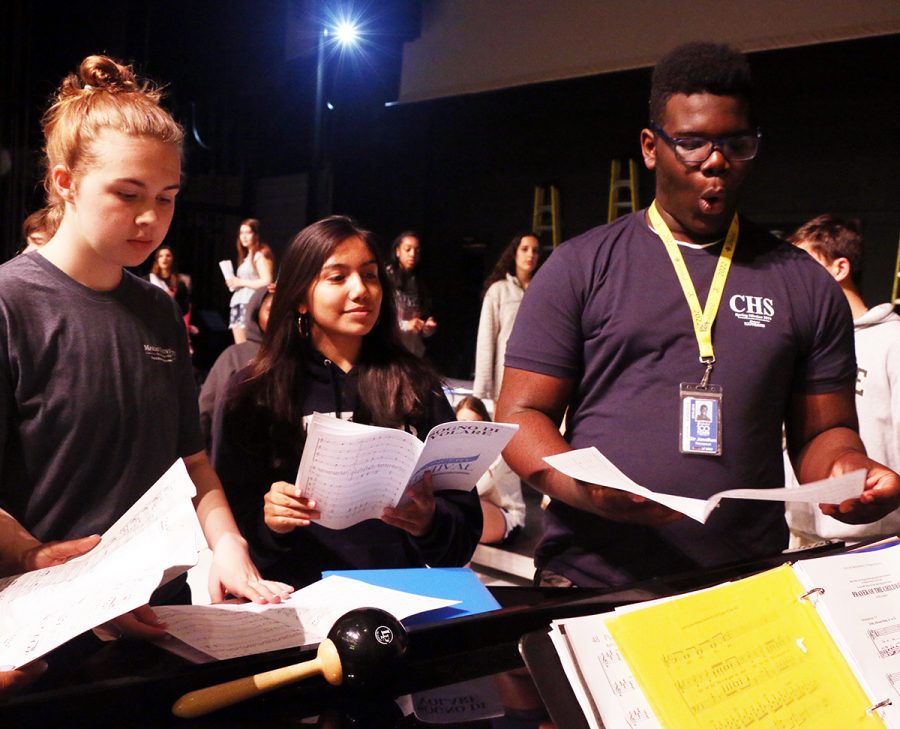 In the auditorium, freshman Sir Jonathan Thompson participates in choir practice during E period. 