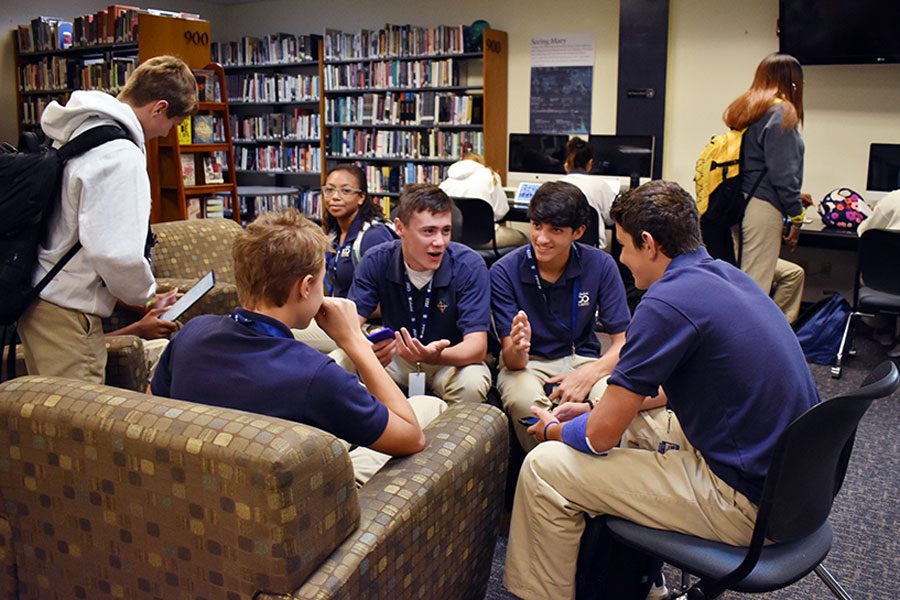 Before school on Aug. 15, a group of freshman boys gathers in the library. The library opens each morning at 7. 