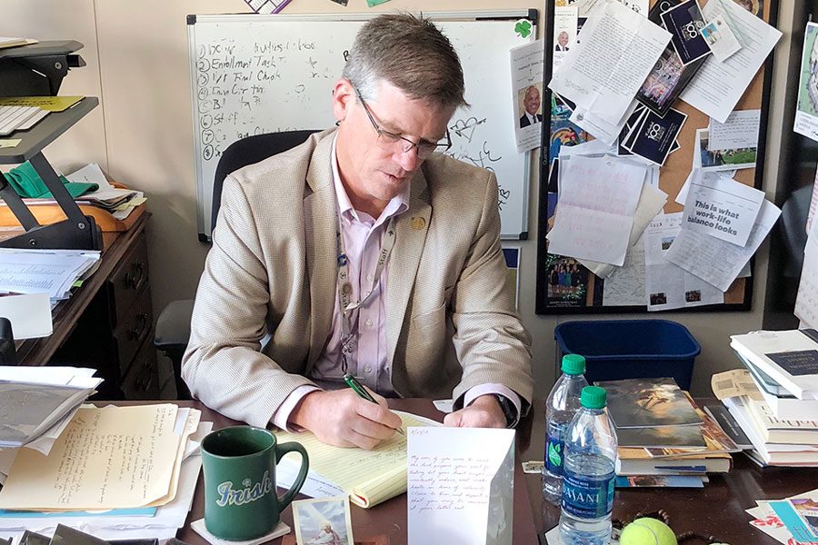 President Dr. Robert Bridges works at his desk in Kelly Hall. 