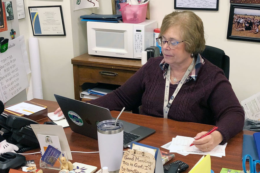 Mrs. Charlene Witka, who serves as the director of campus ministry, works at her desk in her office, which is located in the Shiel Student Life Center. 