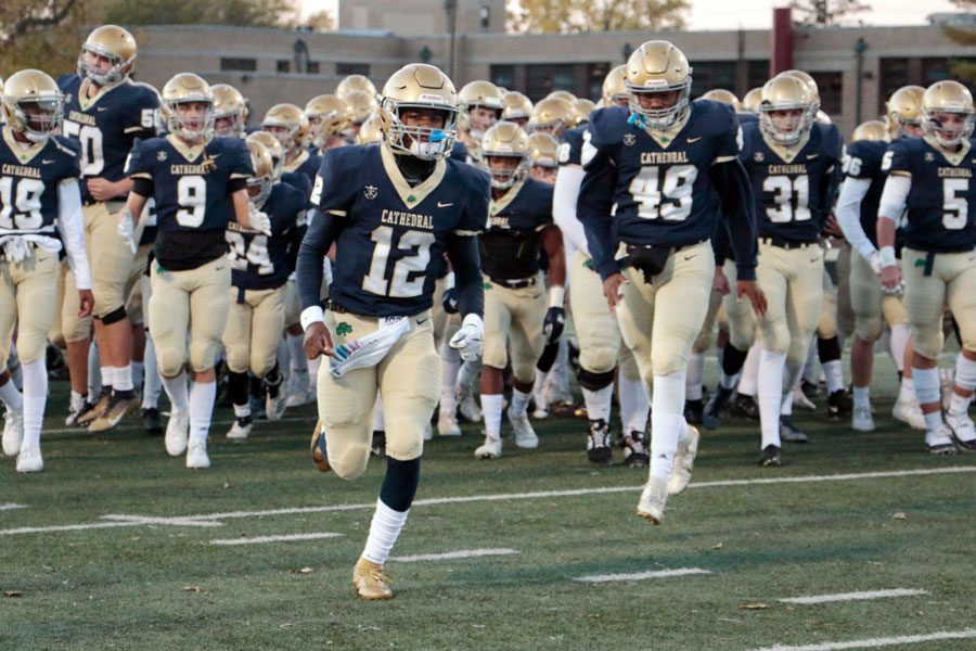 The varsity football team takes the field during the Sectional opener against Terre Haute South. 