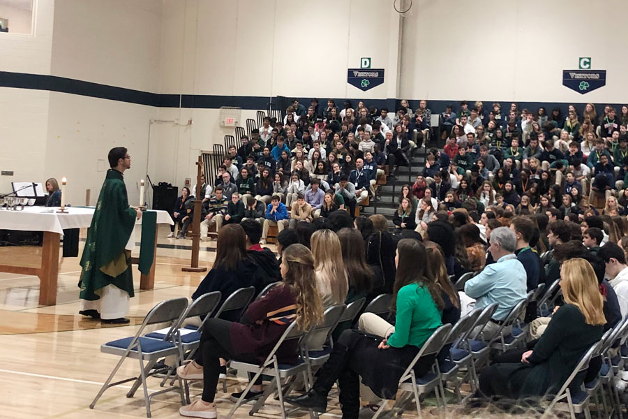 Fr. Dennis Strach celebrates the school's first bilingual Mass on Jan. 29 in the Welch Activity Center. 